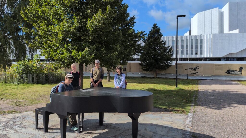 Participants playing the free piano next to the Finlandia house